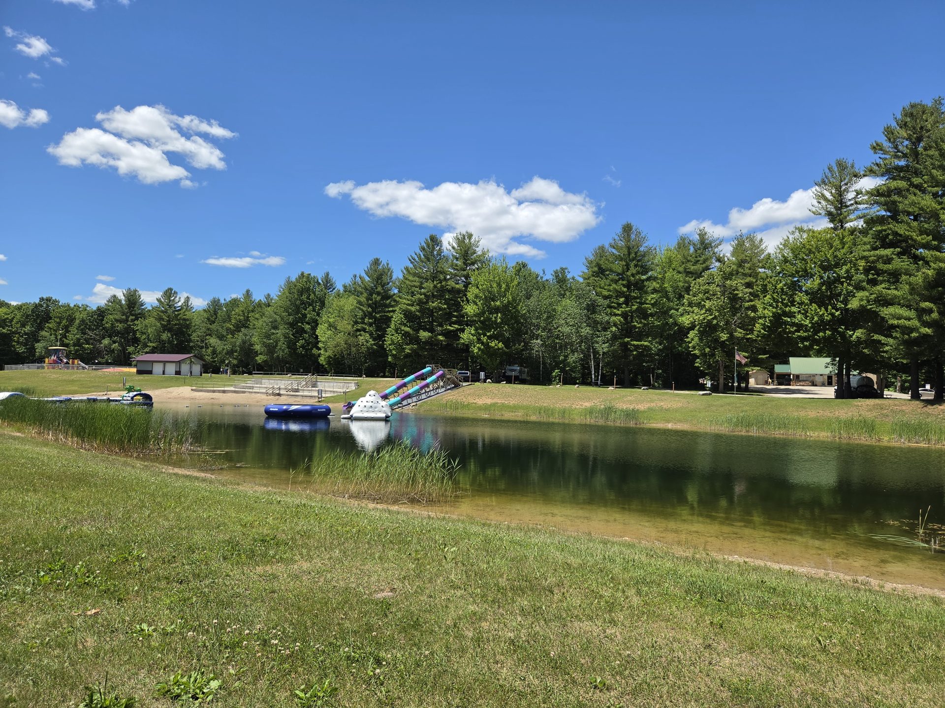 Sandy beach with boats under a blue summer sky